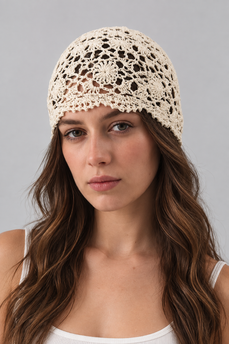 Model wearing a Trestles Clothing Company cream cotton crochet lace beanie with an open knit skull cap design.